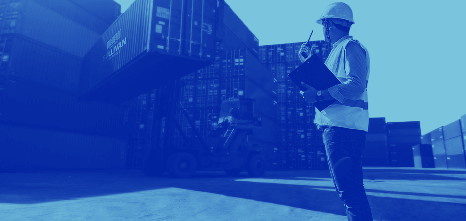 Photo of a worker next to containers
